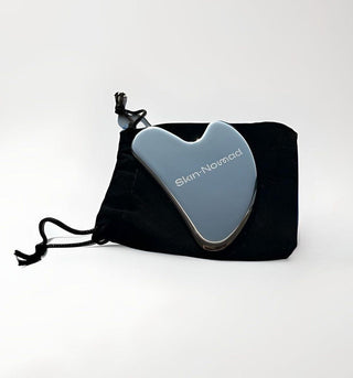 Skin-Nomad stainless steel gua sha with its velvet pouch, a Secret Santa beauty gift under £15