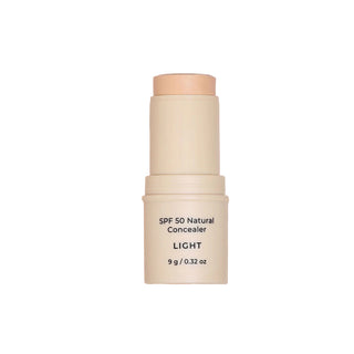SPF 50 Natural Concealer stick with a swatch on a beige background